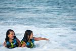 Sisters bonding in the surf.